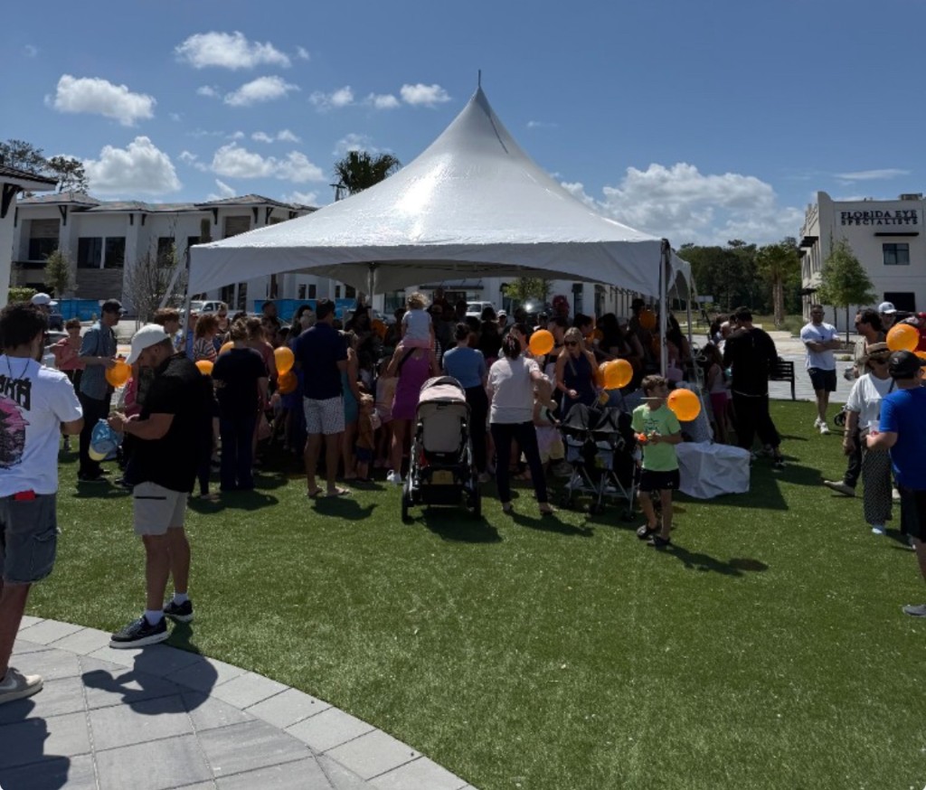 Community Easter event at Fountains at St. Johns with families gathering under a tent