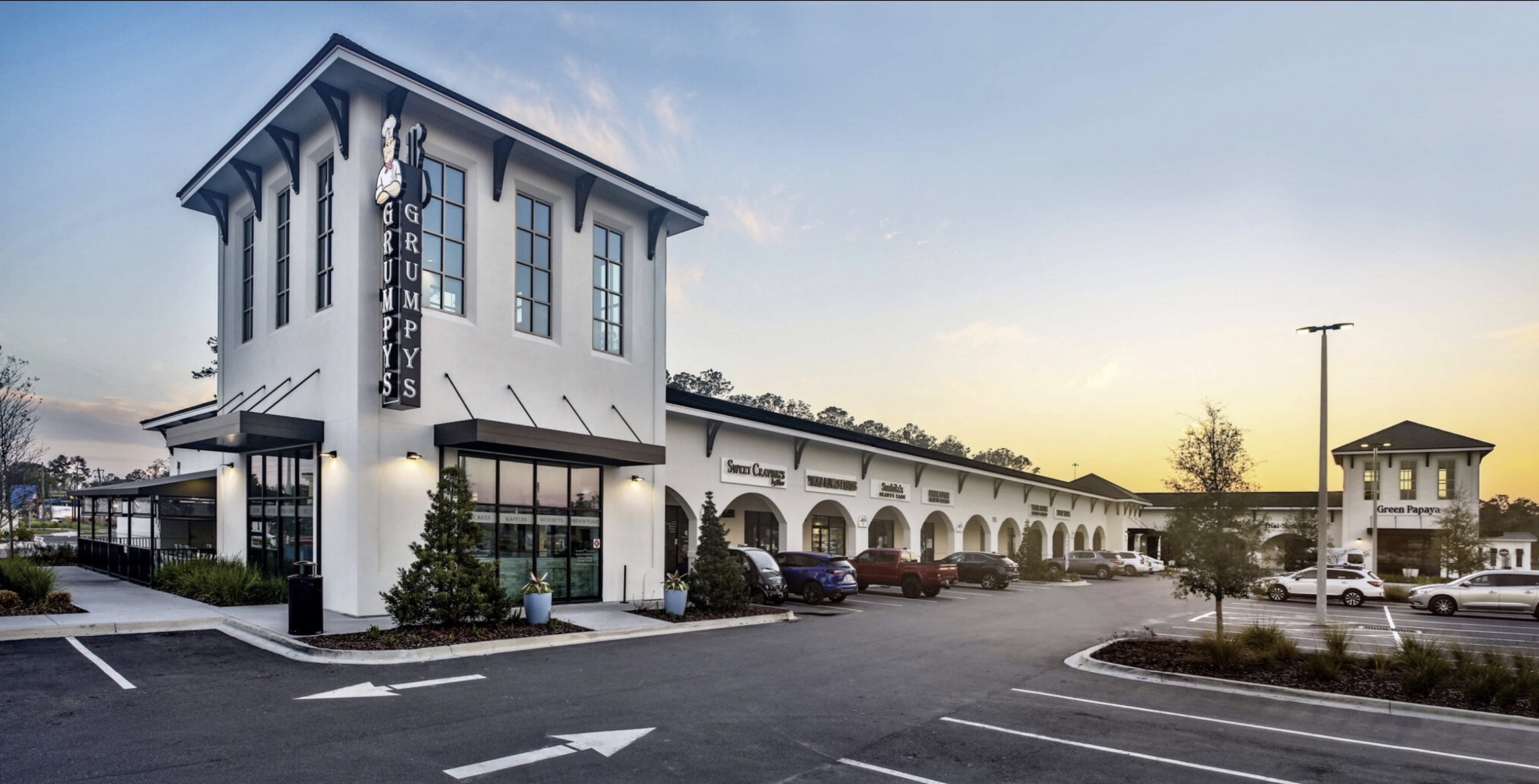 Fountains mixed-use retail and restaurant building at dusk